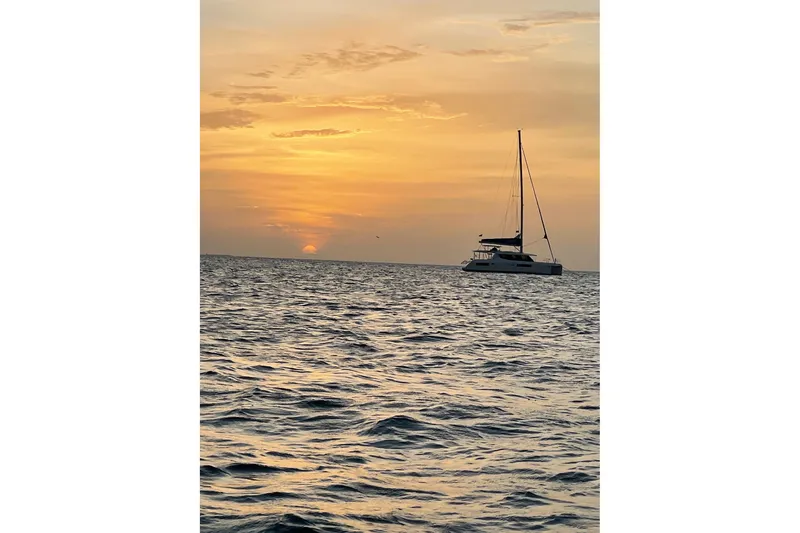 Nice Aft Too Yacht Photos Pics Sailboat Leopard 45 at sunset on the ocean, 2018 model.