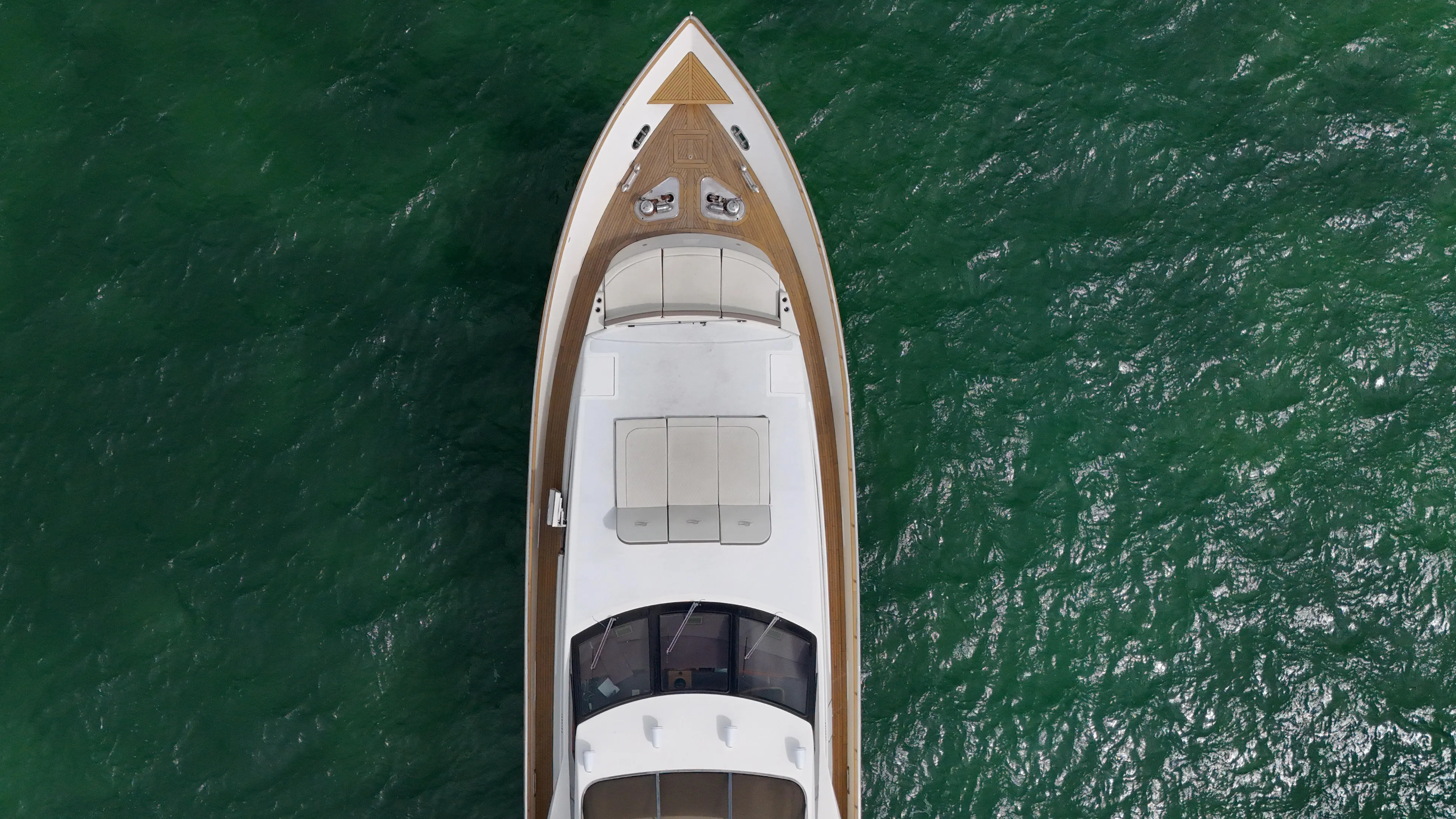  Yacht Photos Pics Top view of a 2006 Azimut 100 Jumbo yacht on green water.