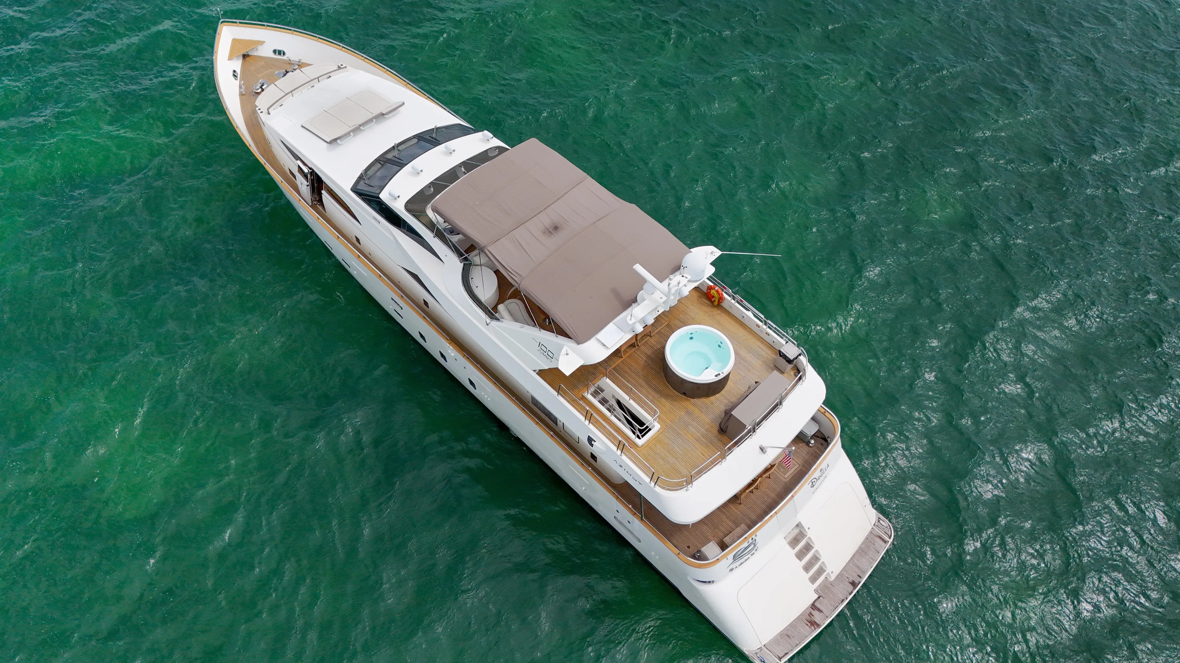  Yacht Photos Pics Aerial view of 2006 Azimut 100 Jumbo yacht cruising on clear waters.