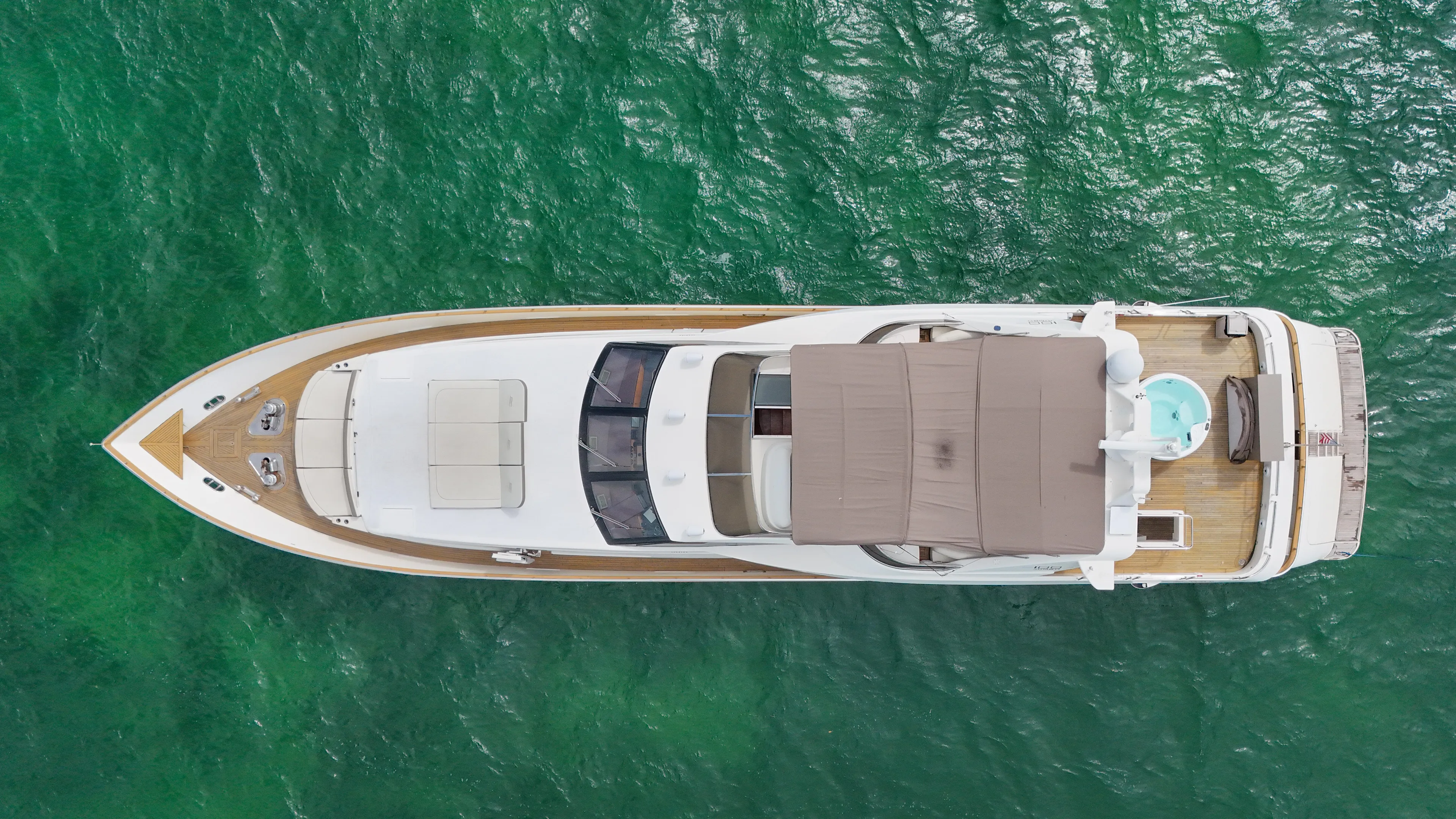  Yacht Photos Pics Top view of 2006 Azimut 100 Jumbo yacht cruising on clear green water.