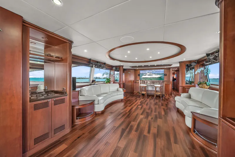  Yacht Photos Pics Luxurious interior of 2006 Azimut 100 Jumbo yacht with elegant wood flooring and white leather seating.