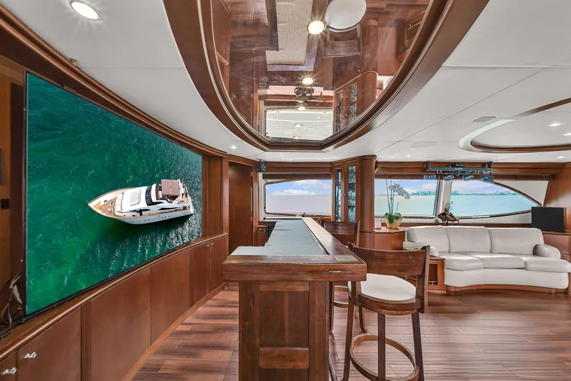  Yacht Photos Pics Luxurious interior of 2006 Azimut 100 Jumbo yacht with wooden finishes and large windows.