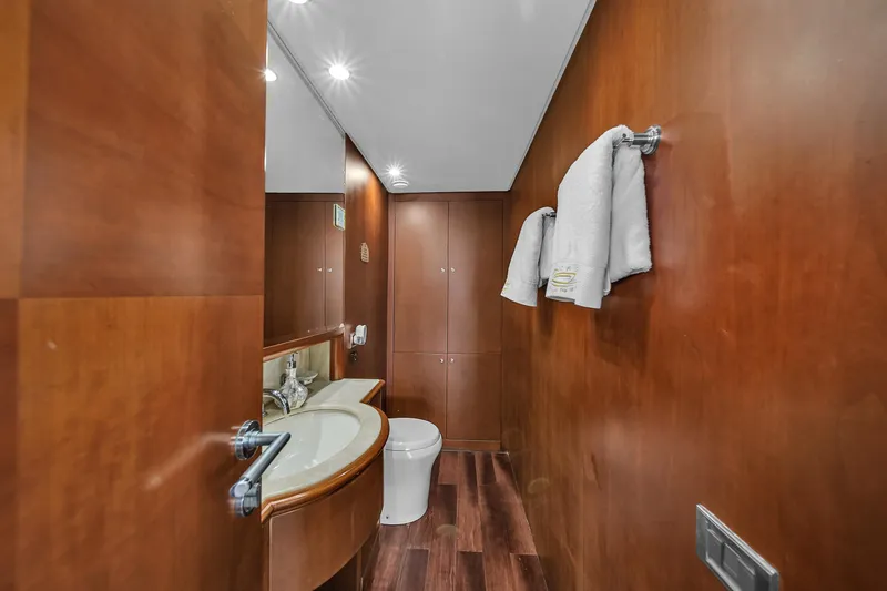  Yacht Photos Pics Luxurious bathroom on 2006 Azimut 100 Jumbo yacht with wooden finishes and modern fixtures.