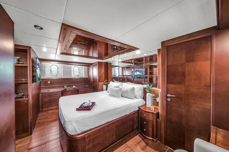  Yacht Photos Pics Luxurious master bedroom on 2006 Azimut 100 Jumbo yacht with elegant wood finishes.