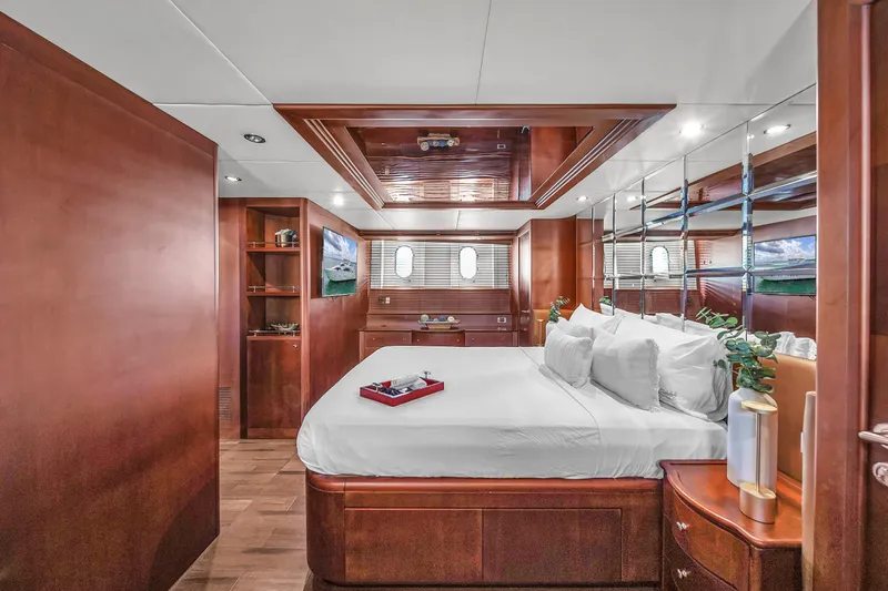  Yacht Photos Pics Luxurious bedroom interior of 2006 Azimut 100 Jumbo yacht with wooden finishes.