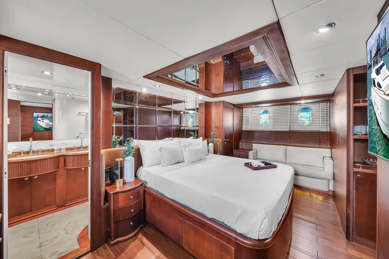  Yacht Photos Pics Luxurious master bedroom on a 2006 Azimut 100 Jumbo yacht with elegant wood finishes.