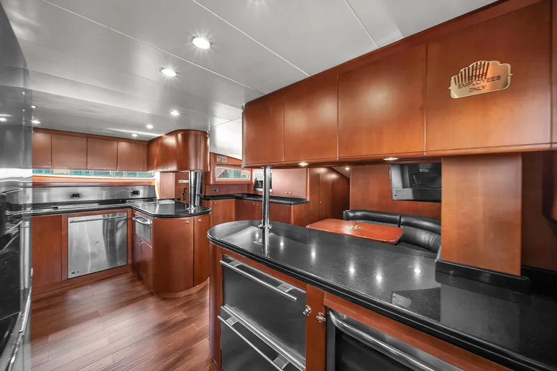  Yacht Photos Pics Luxurious kitchen interior of 2006 Azimut 100 Jumbo yacht with modern appliances and wooden cabinetry.