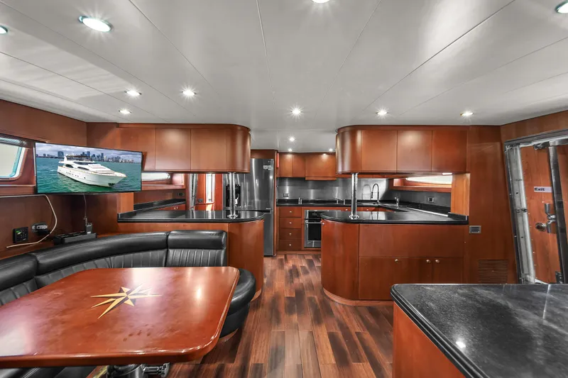  Yacht Photos Pics Luxurious interior of 2006 Azimut 100 Jumbo yacht with modern kitchen and dining area.