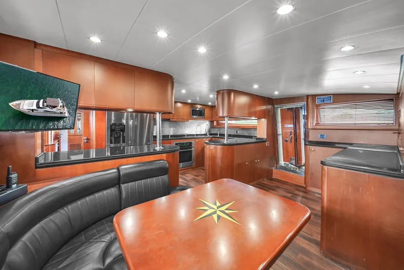  Yacht Photos Pics Luxurious interior of 2006 Azimut 100 Jumbo yacht with modern kitchen and dining area.