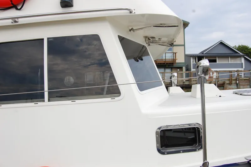  Yacht Photos Pics 1981 Willard Marine Pilot House Trawler, side view with windows and railing.