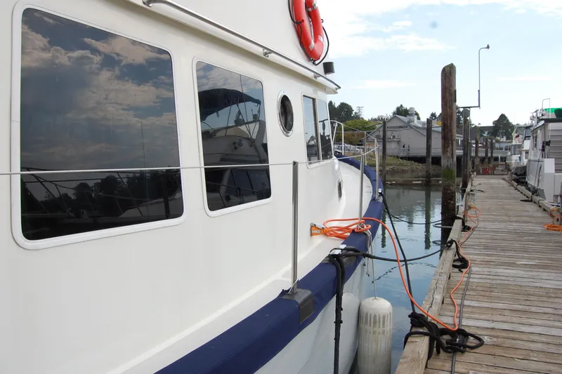  Yacht Photos Pics 1981 Willard Marine Pilot House Trawler docked at a marina with reflections on windows.