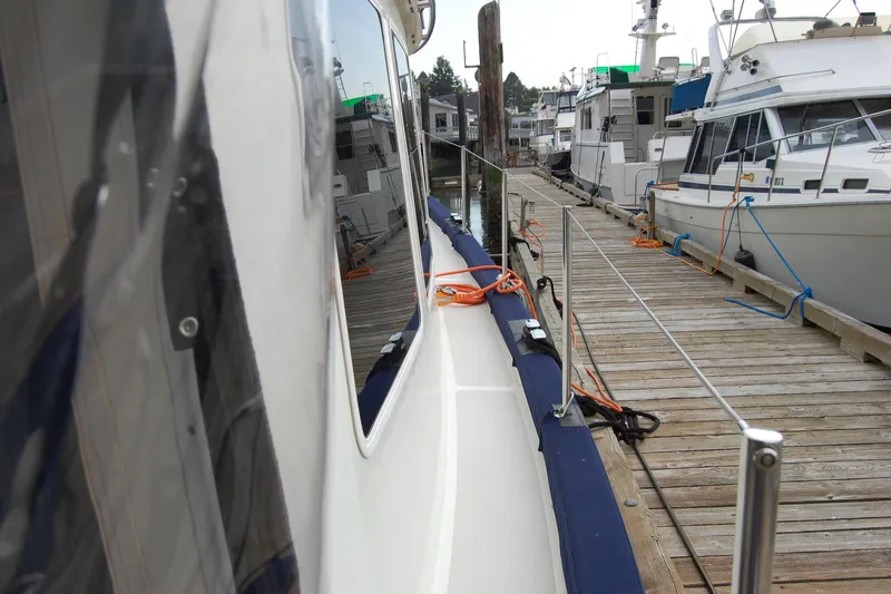  Yacht Photos Pics 1981 Willard Marine Pilot House Trawler docked at a marina with wooden pier.