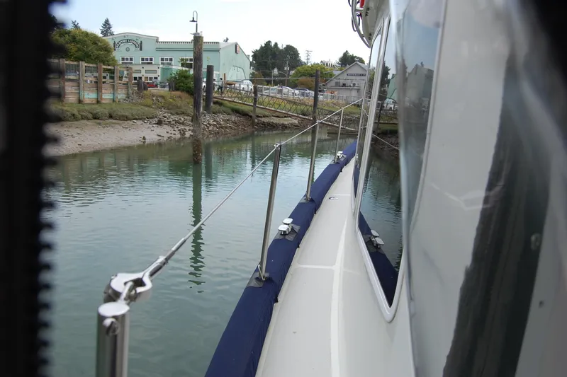  Yacht Photos Pics 1981 Willard Marine Pilot House Trawler docked near a calm waterfront.