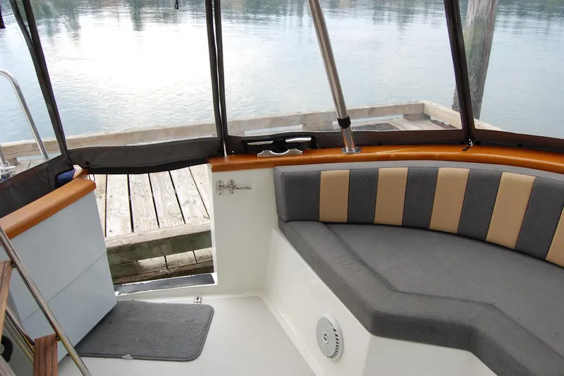  Yacht Photos Pics Interior of 1981 Willard Marine Pilot House Trawler with cushioned seating and dock view.