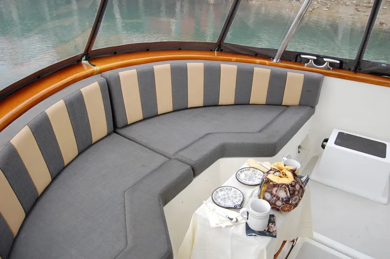  Yacht Photos Pics 1981 Willard Marine Pilot House Trawler interior with striped seating and a table set for tea.