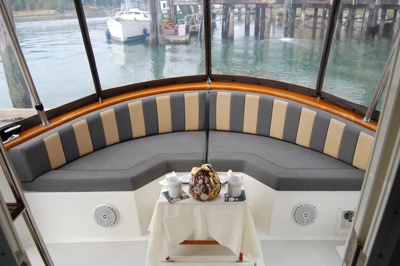  Yacht Photos Pics Cozy seating area on 1981 Willard Marine Pilot House Trawler with table and scenic water view.