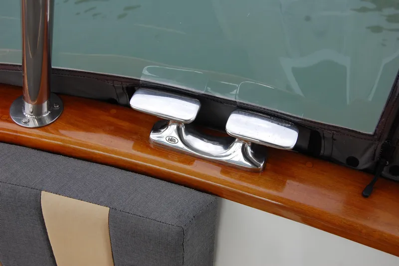  Yacht Photos Pics Close-up of 1981 Willard Marine Pilot House Trawler's polished metal cleat and wooden trim.