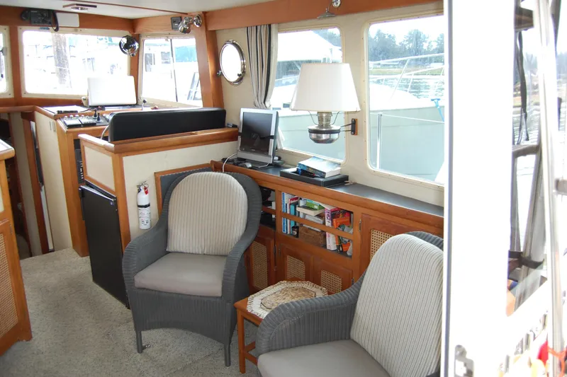  Yacht Photos Pics Interior of 1981 Willard Marine Pilot House Trawler with seating, lamp, and navigation equipment.