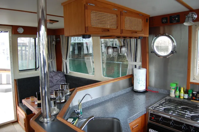  Yacht Photos Pics Interior of 1981 Willard Marine Pilot House Trawler with kitchen and dining area.
