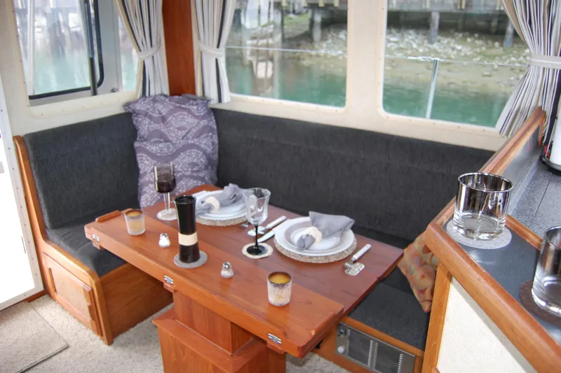  Yacht Photos Pics Cozy dining area in 1981 Willard Marine Pilot House Trawler with elegant table setting.