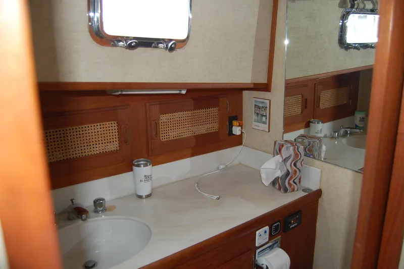  Yacht Photos Pics 1981 Willard Marine Pilot House Trawler bathroom with wooden cabinetry and sink.
