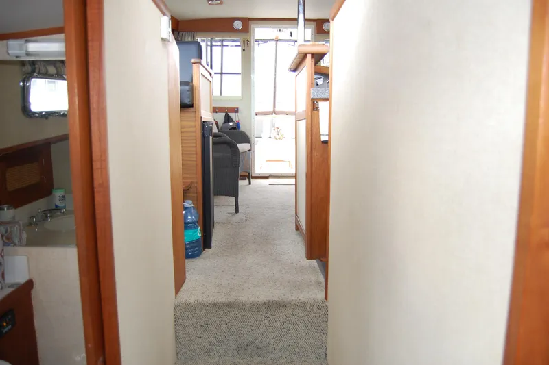 Yacht Photos Pics Interior view of 1981 Willard Marine Pilot House Trawler, featuring hallway and seating area.