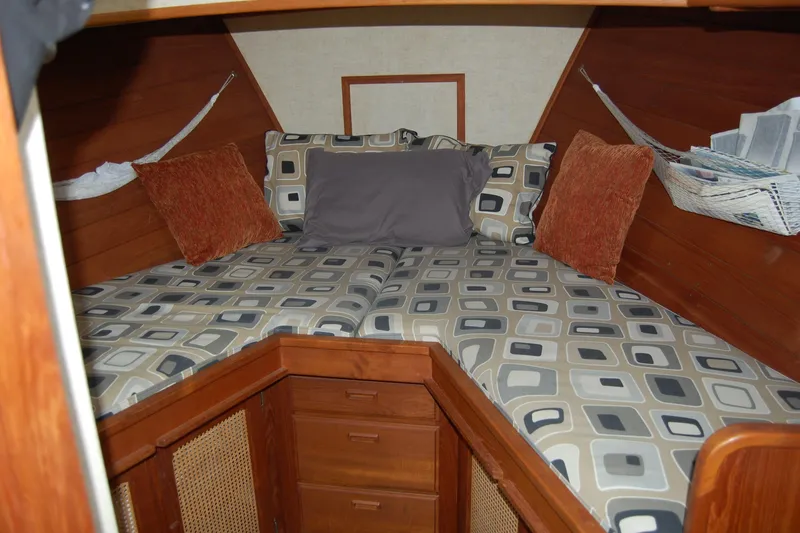  Yacht Photos Pics Cozy cabin interior of 1981 Willard Marine Pilot House Trawler with patterned bedding.