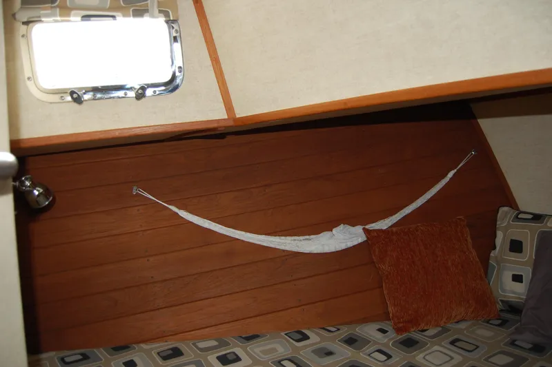  Yacht Photos Pics Cozy cabin interior of 1981 Willard Marine Pilot House Trawler with cushions and hammock.