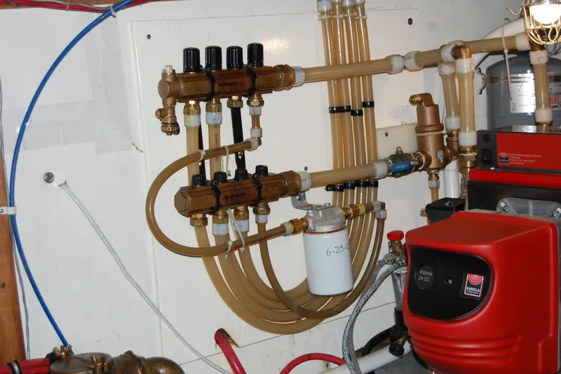  Yacht Photos Pics Engine room of 1981 Willard Marine Pilot House Trawler with complex piping system.