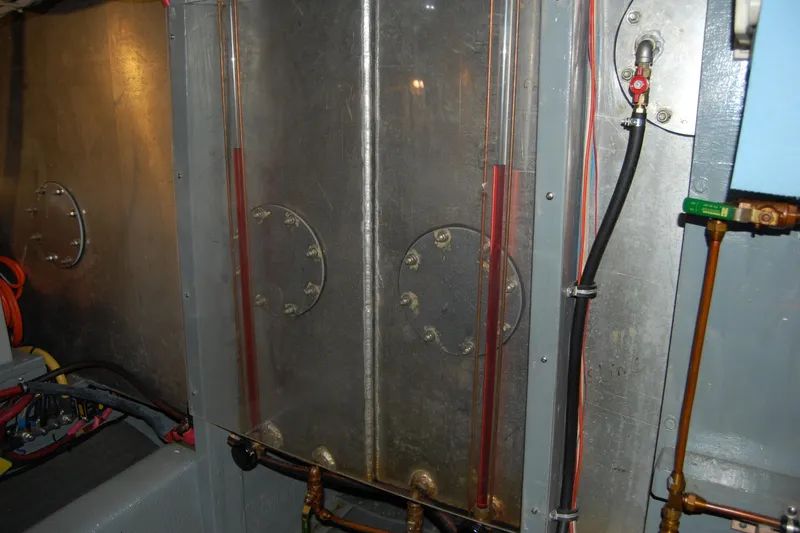  Yacht Photos Pics Engine room of 1981 Willard Marine Pilot House Trawler with visible pipes and wiring.