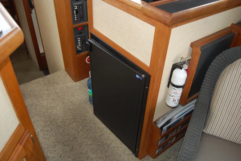  Yacht Photos Pics Interior of 1981 Willard Marine Pilot House Trawler with fridge and fire extinguisher.