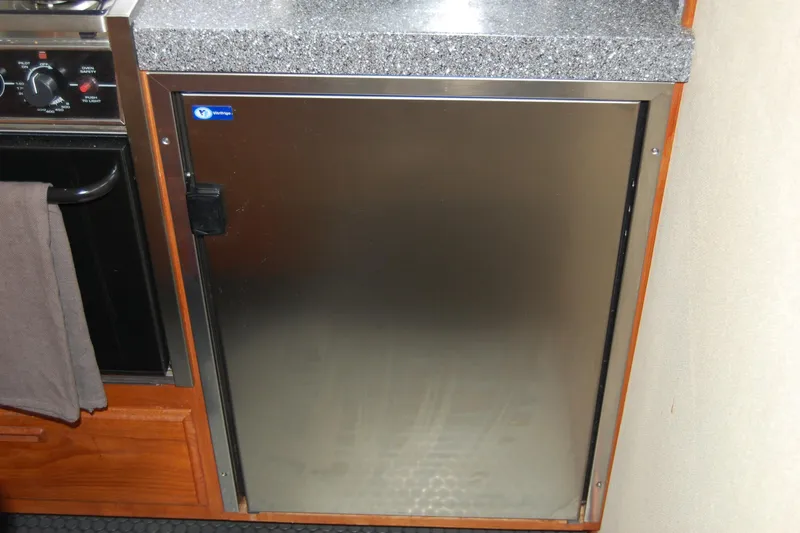  Yacht Photos Pics Stainless steel refrigerator in 1981 Willard Marine Pilot House Trawler kitchen.