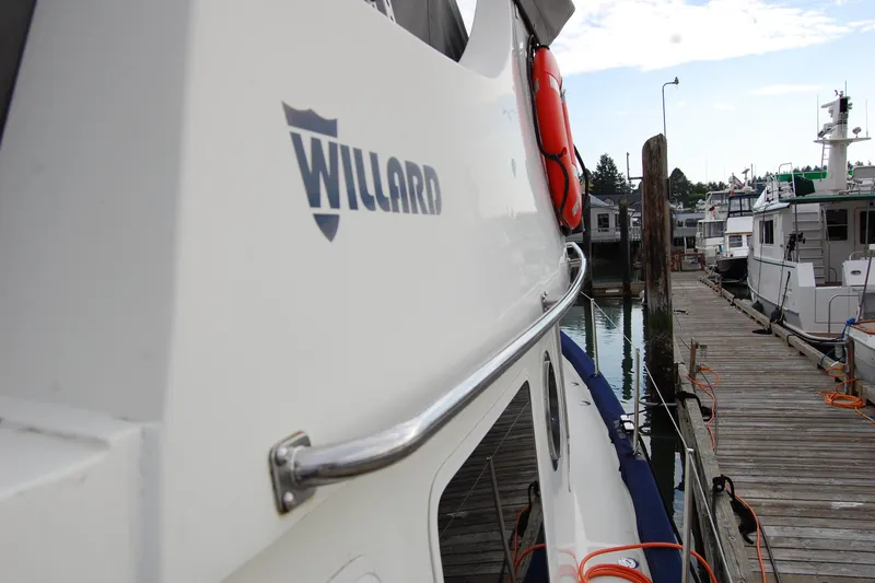  Yacht Photos Pics 1981 Willard Marine Pilot House Trawler docked at marina, side view with logo.