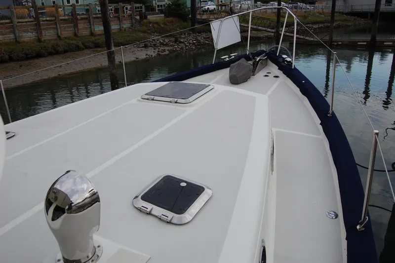  Yacht Photos Pics 1981 Willard Marine Pilot House Trawler deck with hatches, docked in a marina.