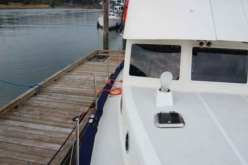  Yacht Photos Pics 1981 Willard Marine Pilot House Trawler docked at a wooden pier.