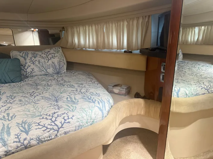  Yacht Photos Pics Interior of 2003 Sea Ray 380 Sundancer with cozy bed and nautical-themed bedding.