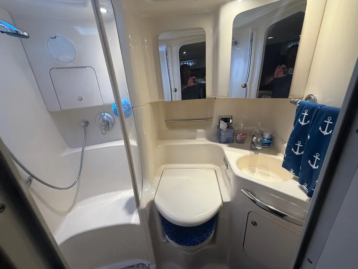  Yacht Photos Pics Bathroom interior of 2003 Sea Ray 380 Sundancer yacht, featuring shower and nautical decor.