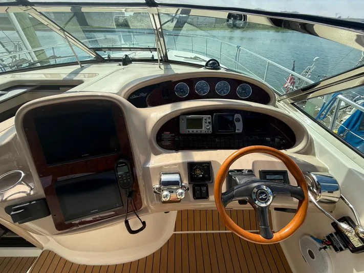  Yacht Photos Pics 2003 Sea Ray 380 Sundancer helm with wood steering wheel and navigation instruments.