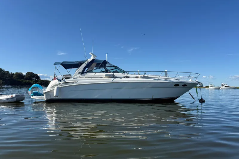  Yacht Photos Pics 2003 Sea Ray 380 Sundancer yacht anchored on calm water under clear blue sky.