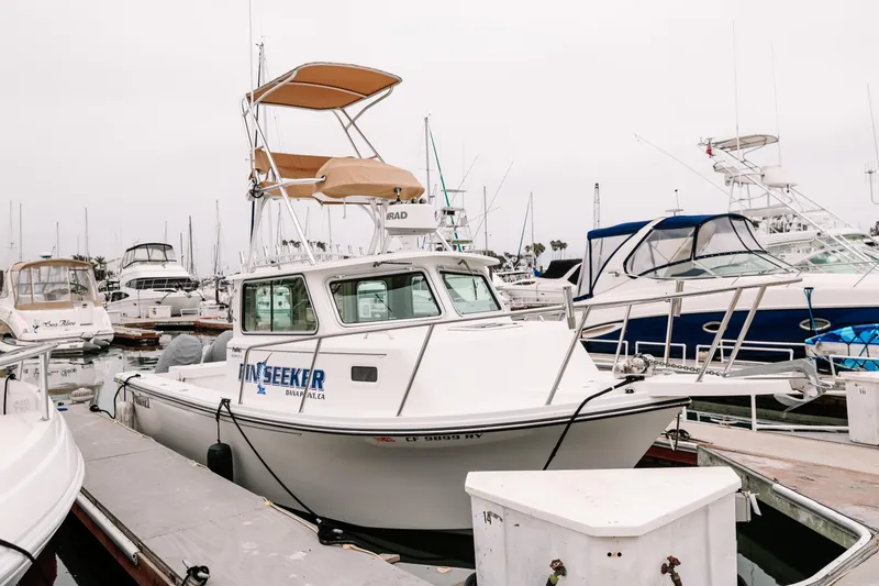  Yacht Photos Pics 2017 Parker 2520 XLD Sport Cabin boat docked in marina, overcast sky.