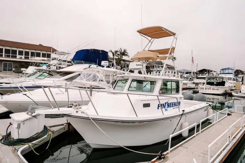  Yacht Photos Pics 2017 Parker 2520 XLD Sport Cabin boat docked in a marina, surrounded by other vessels.