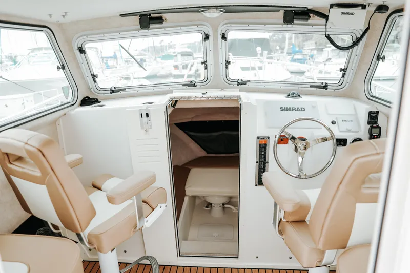  Yacht Photos Pics 2017 Parker 2520 XLD Sport Cabin interior with steering wheel and seating.