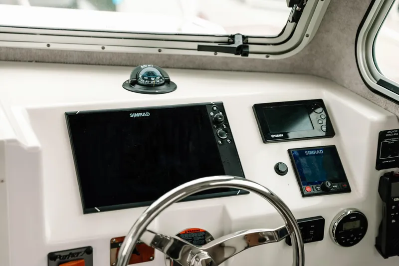  Yacht Photos Pics Dashboard of 2017 Parker 2520 XLD Sport Cabin with navigation instruments and steering wheel.