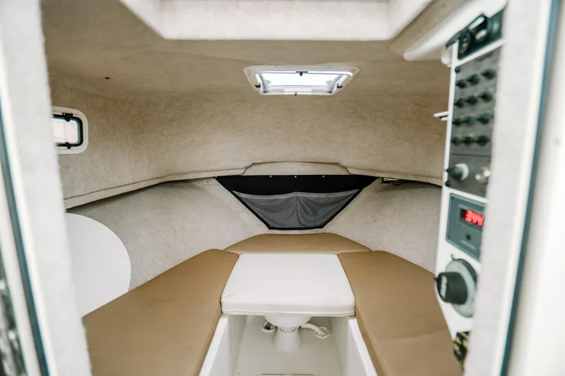  Yacht Photos Pics 2017 Parker 2520 XLD Sport Cabin interior with beige seating and control panel.