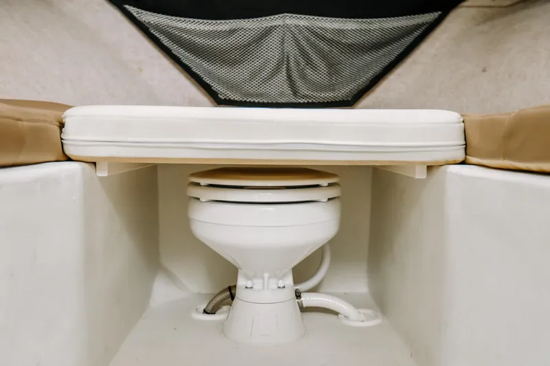  Yacht Photos Pics 2017 Parker 2520 XLD Sport Cabin interior with marine toilet and cushioned seating.