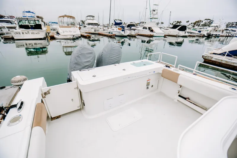  Yacht Photos Pics 2017 Parker 2520 XLD Sport Cabin boat docked in a marina with other vessels.