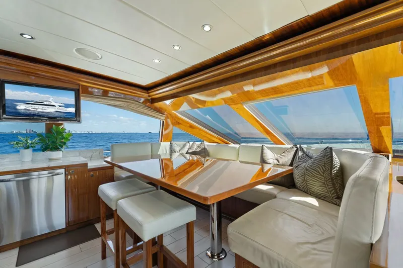 Mesmerize Yacht Photos Pics Luxurious interior of 2013 Hargrave 125 Raised Pilothouse yacht with ocean view and elegant seating.