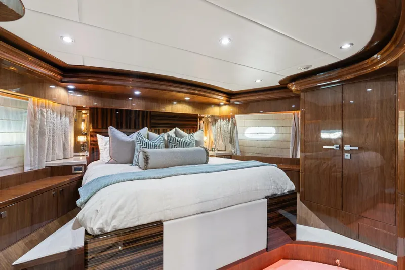 Mesmerize Yacht Photos Pics Luxurious bedroom interior of 2013 Hargrave 125 Raised Pilothouse yacht with elegant wood finishes.