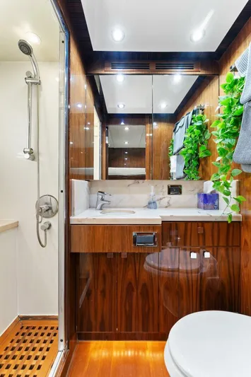 Mesmerize Yacht Photos Pics Luxurious bathroom in 2013 Hargrave 125 Raised Pilothouse yacht with wood accents and modern fixtures.