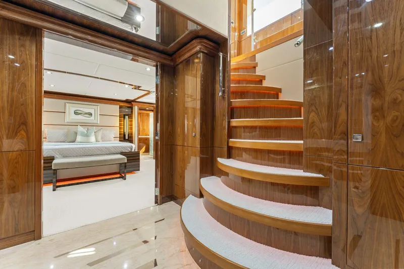 Mesmerize Yacht Photos Pics Luxurious interior of 2013 Hargrave 125 Raised Pilothouse yacht with elegant staircase and bedroom.